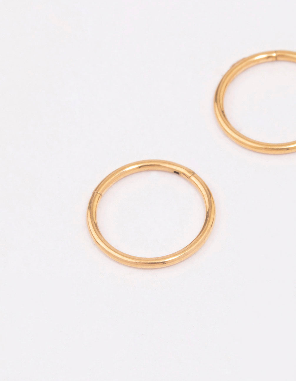 Showcasing gold plated titanium sleeper earrings in 8mm close up view