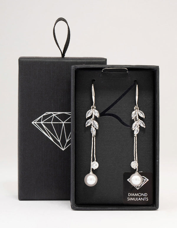 Showcasing silver cubic zirconia leaf and pearl drop earrings front view