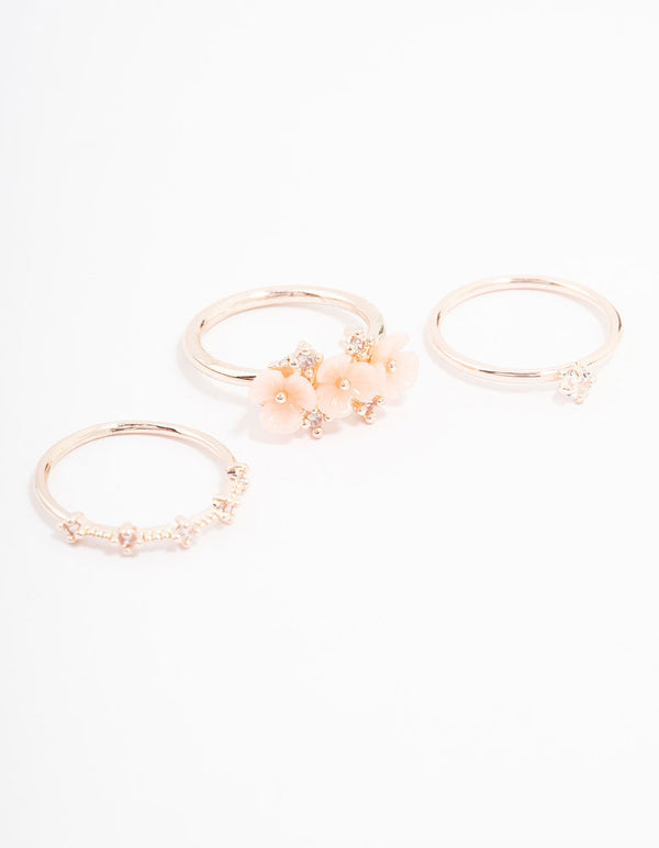 Showcasing rose gold plated triple flower stacking ring pack in dainty style front view