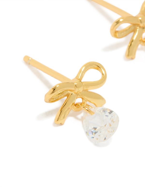 Crafted from gold plated sterling silver, these bow earrings with statement style feature pear cut crystal close up view
