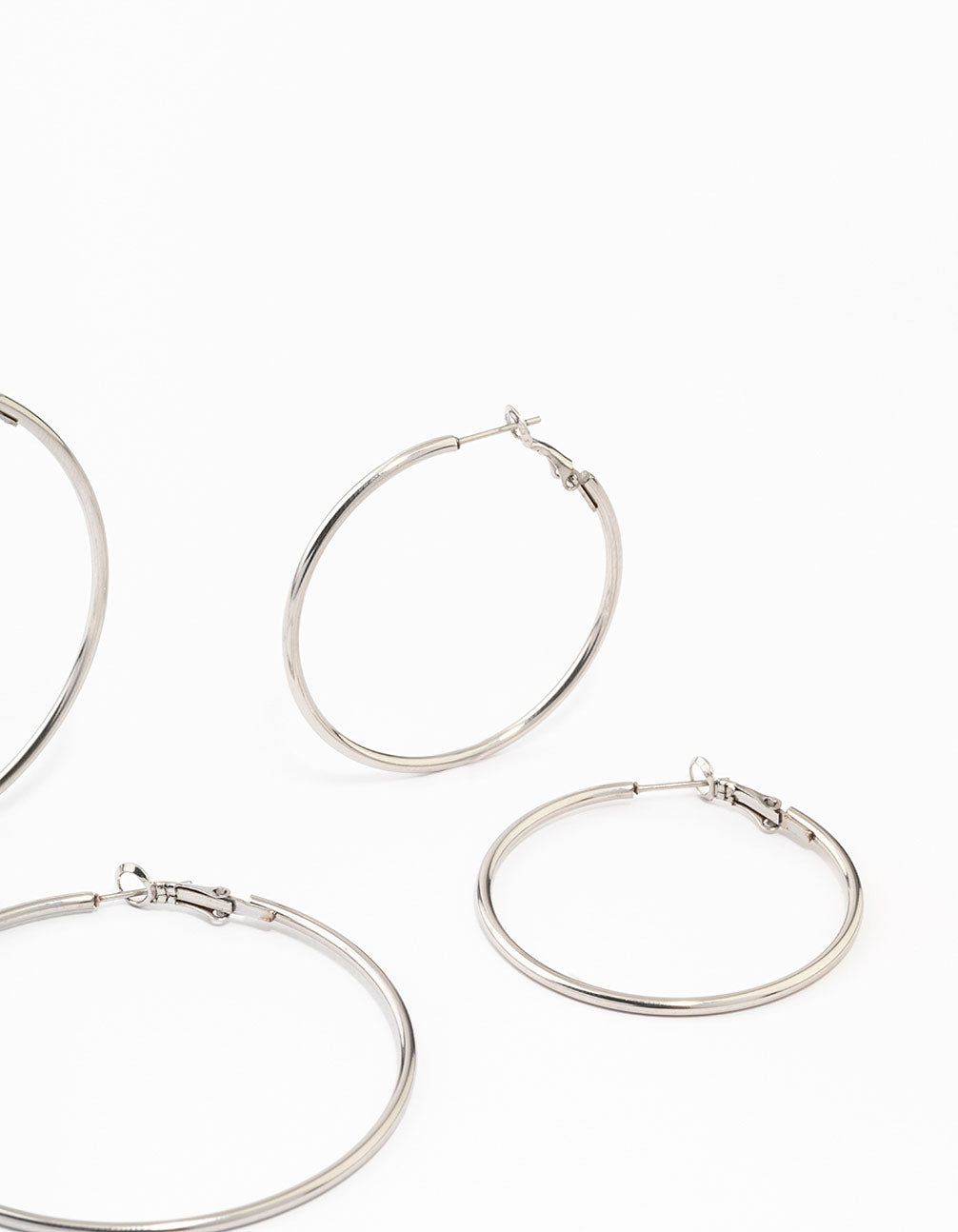 Highlighting waterproof stainless steel thin hoop earrings in a silver 3-pack post detail view