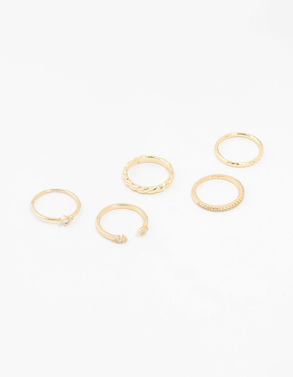 Featuring gold plated dainty diamante rings in a 5-pack with varied band styles front view