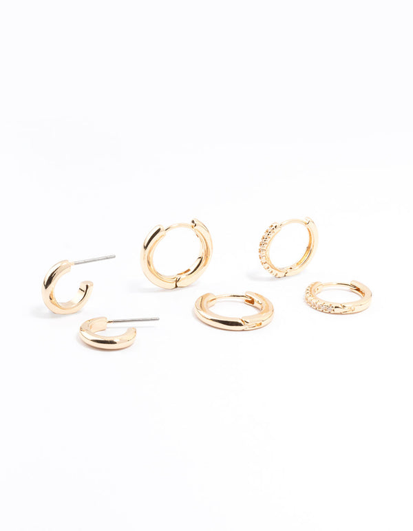 Featuring gold minimal huggie hoop earrings in a stackable 3-pack front view