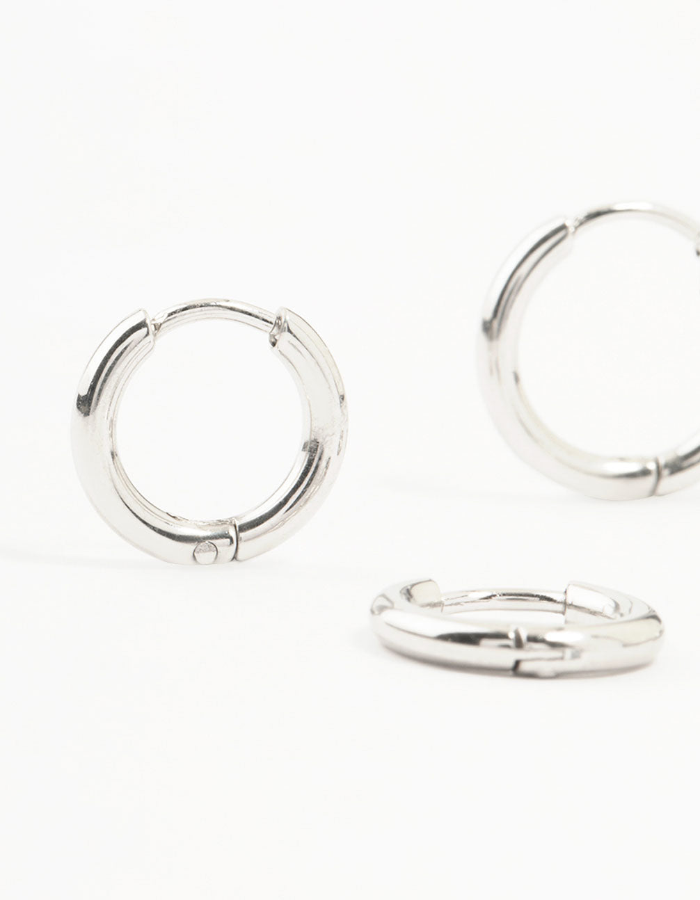 Featuring surgical steel classic hoop earrings in a 2-pack with silver finish close up view