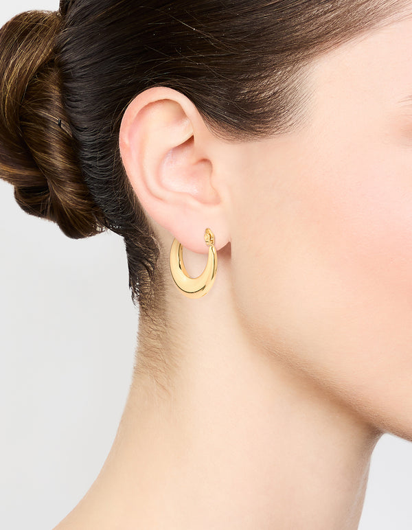 Crafted from waterproof gold plated stainless steel, these crescent hoop earrings on ear view