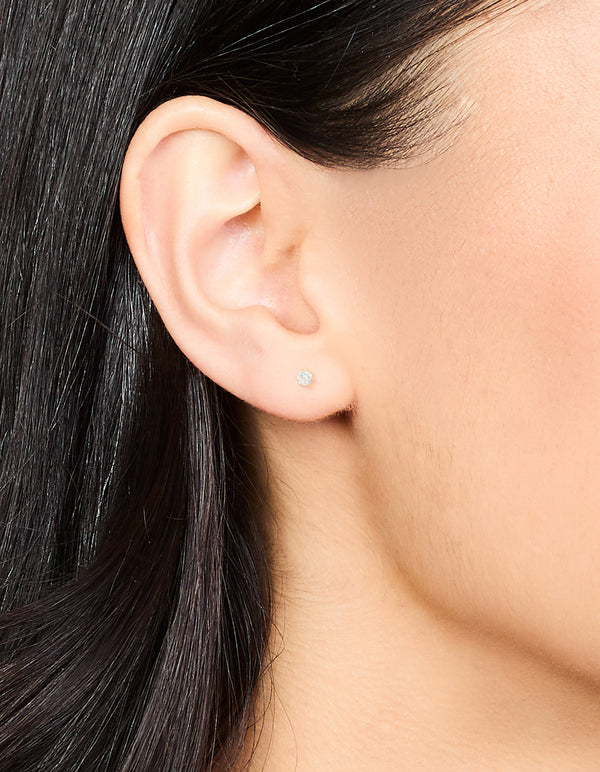 Showcasing waterproof gold plated stainless steel cubic zirconia stud earrings in 3 MM size on ear view