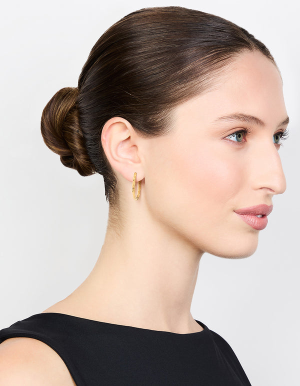 Displaying waterproof gold plated stainless steel twisted hoop earrings on model view