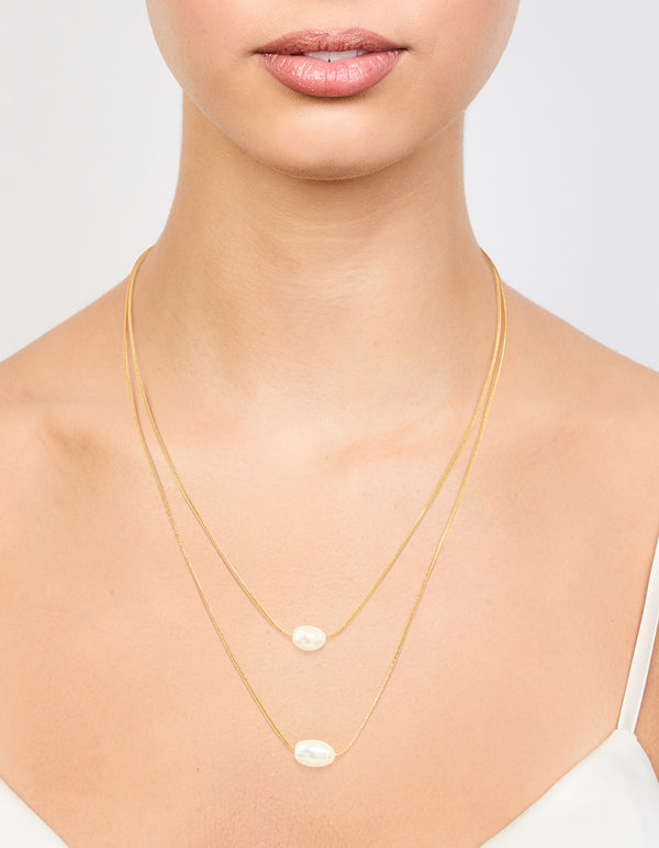 Elegantly displayed waterproof gold plated stainless steel layered pearl pendant necklace on neck view
