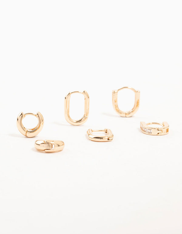 Showcasing gold cubic zirconia oval huggie earrings in a 3-pack featuring mixed designs front view