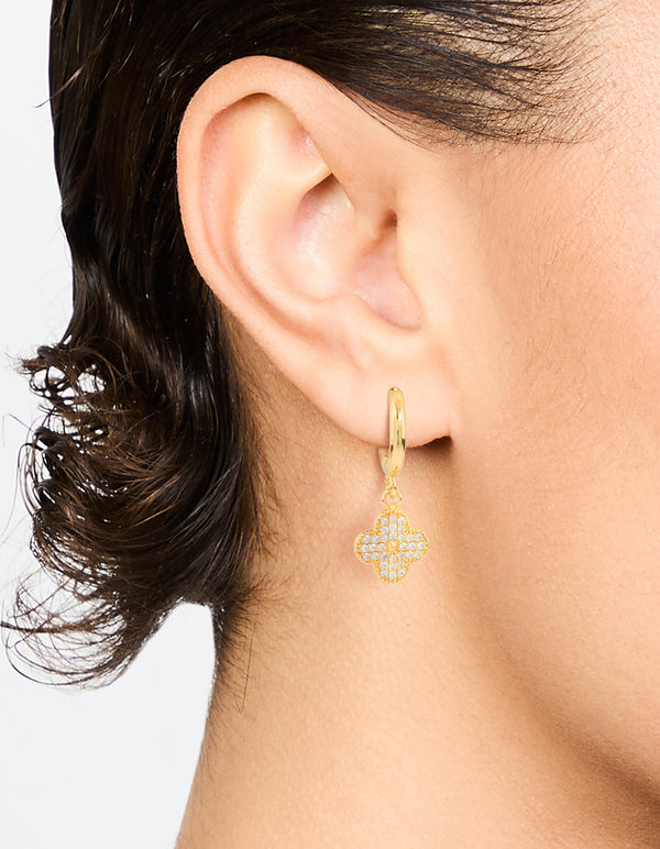 Showcasing gold plated cubic zirconia flower drop earrings with floral design on ear view