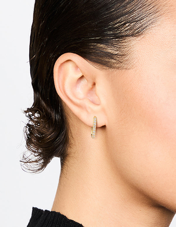 These gold plated diamante oval hoop earrings showcase elegant design on ear view