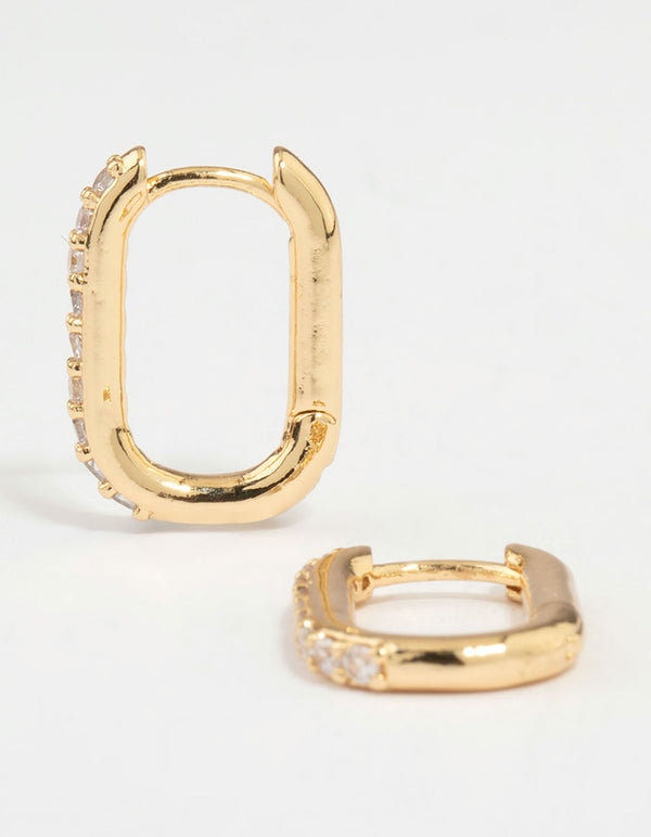 Crafted from gold plated metal, these diamante oval hoop earrings feature clear stones in a hoop closure front view