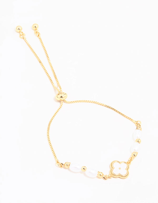 Beautifully designed gold plated pearl flower toggle bracelet with beads, charm accents, and white details front view