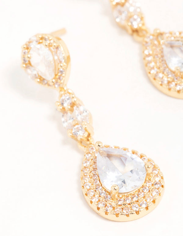 Displaying gold cubic zirconia halo pear drop earrings with clear accents close up view