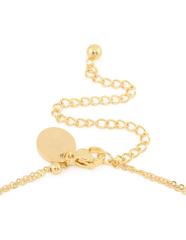 Featuring a waterproof gold plated stainless steel layered necklace with balls, ocean-inspired shell and star charms in gold clasp detail view