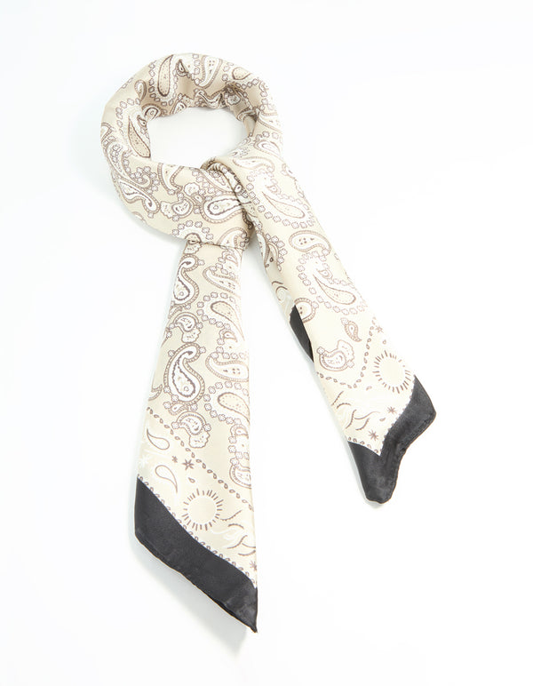 Showcasing a fabric scarf with paisley print in white, tan, and black front view