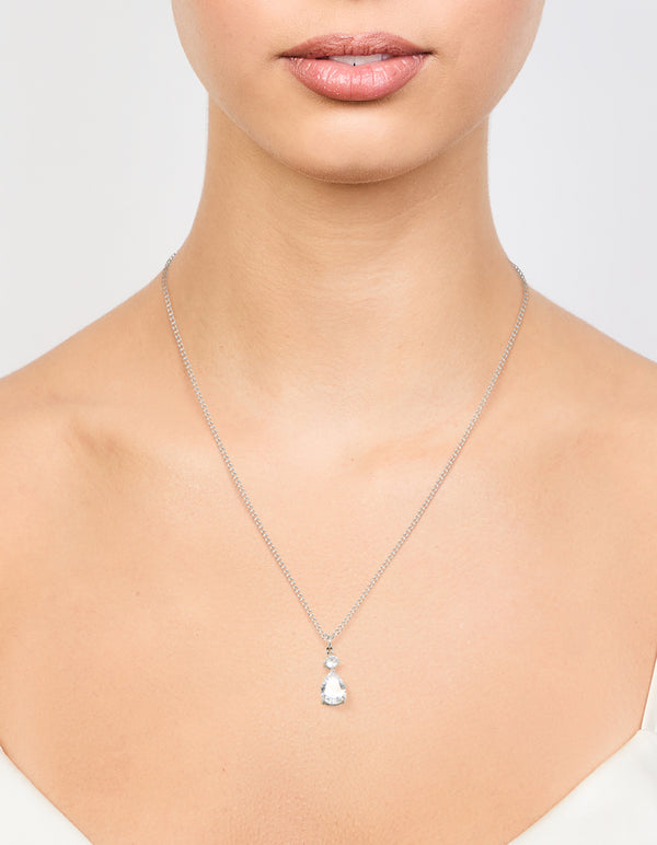 Showcasing a waterproof stainless steel cubic zirconia pear pendant necklace in silver and clear on neck view