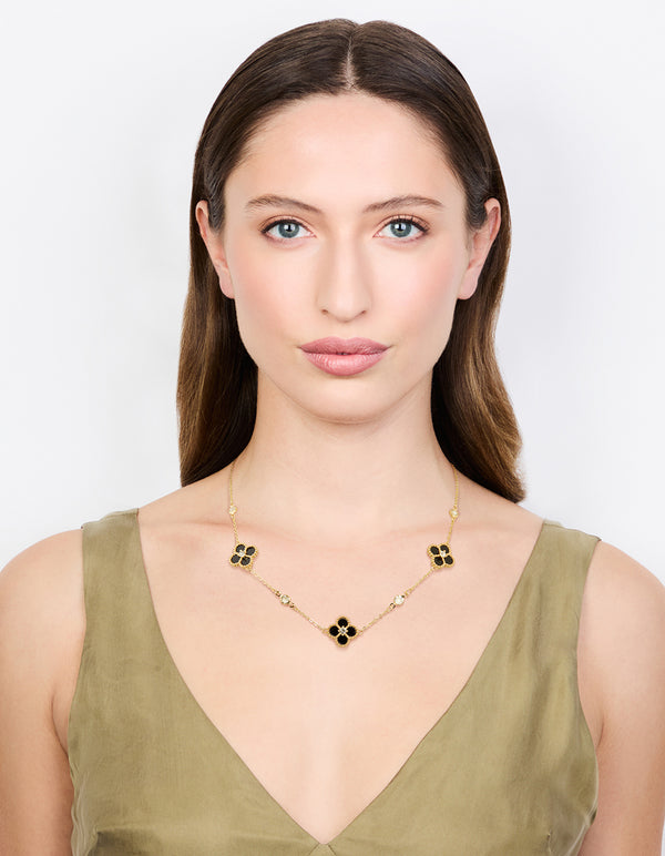 Designed with gold plated cubic zirconia black flower pendant necklace featuring floral and crystal accents on model view