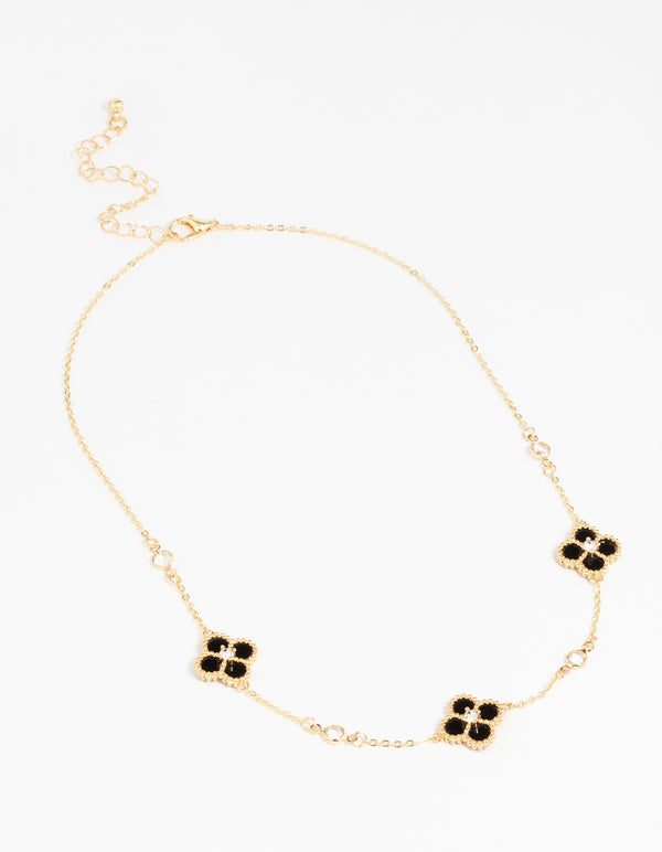 Featuring gold plated cubic zirconia black flower pendant necklace with floral details and crystal elements front view