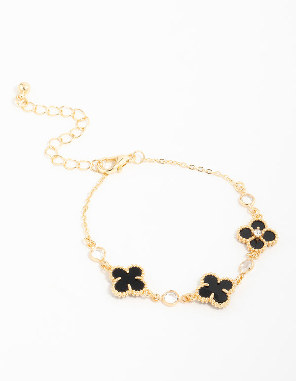 Showcasing a gold plated cubic zirconia black flower charm bracelet in dainty styles front view