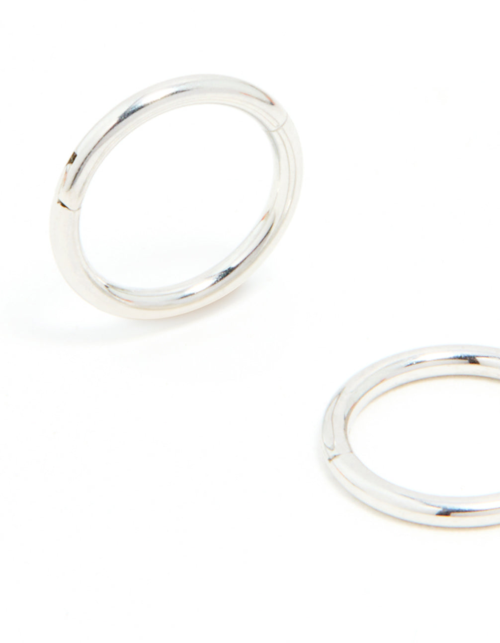 Showcasing surgical steel sleeper earrings in 7mm with dainty design and silver finish close up view