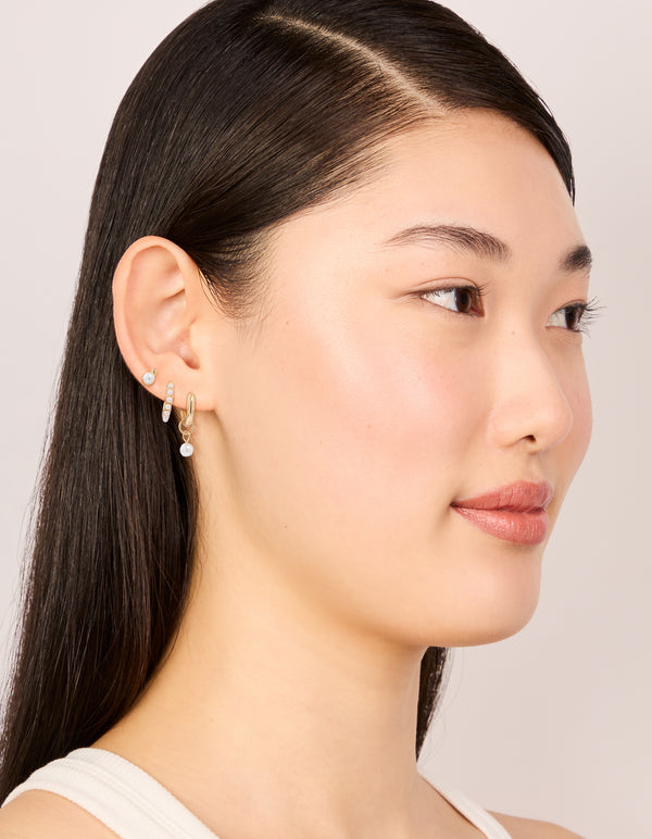 Designed with gold mixed pearl huggie earrings in a 3-pack on model view