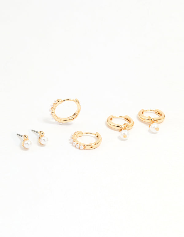 Featuring gold mixed pearl huggie earrings in a 3-pack front view
