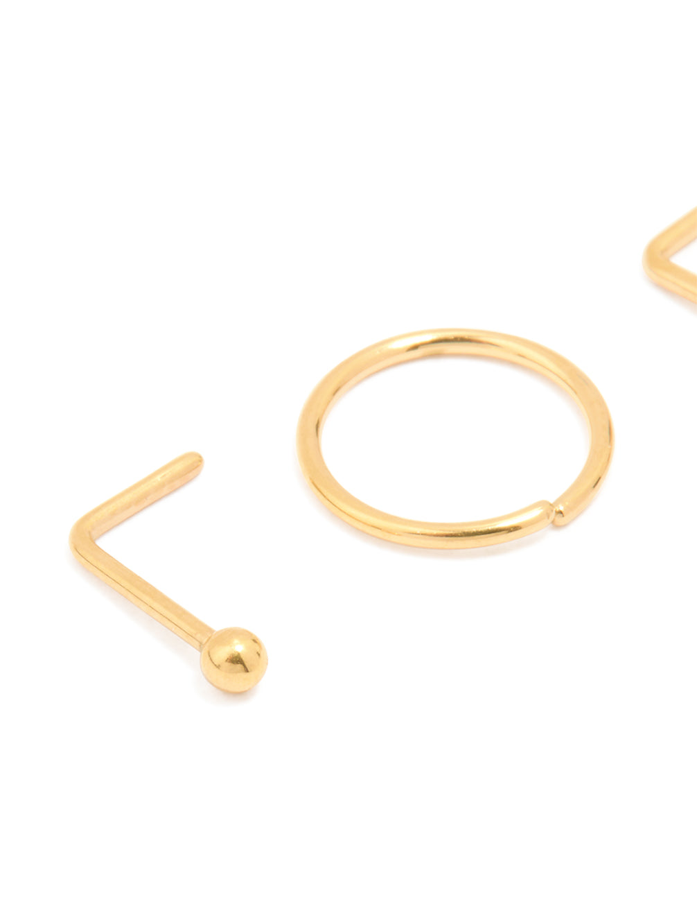 Crafted from titanium with balls and clear stone accents, this simple mixed nose studs and nose rings 4-pack in gold plated statement style detail view