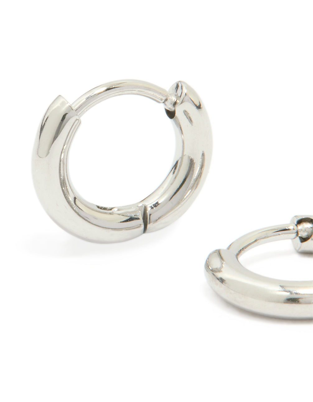 Featuring waterproof stainless steel clicker hoop earrings in silver close up view