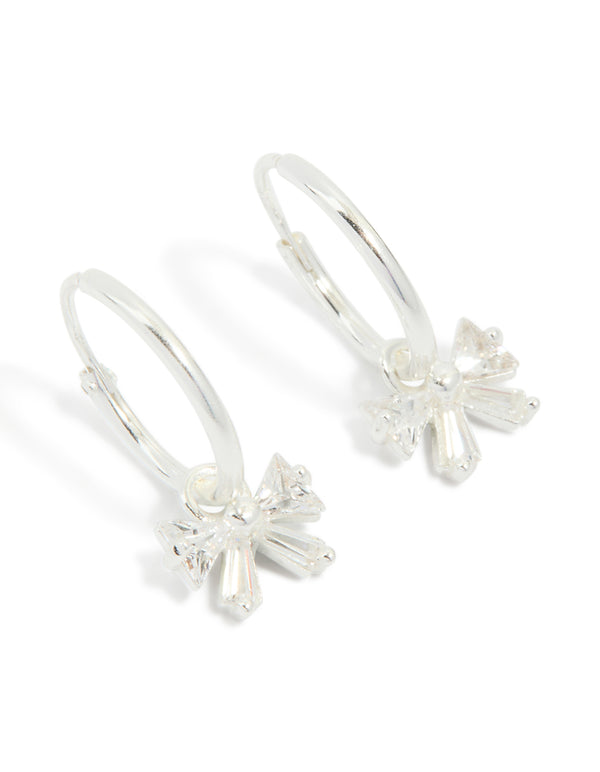 Showcasing sterling silver cubic zirconia bow huggie earrings front view
