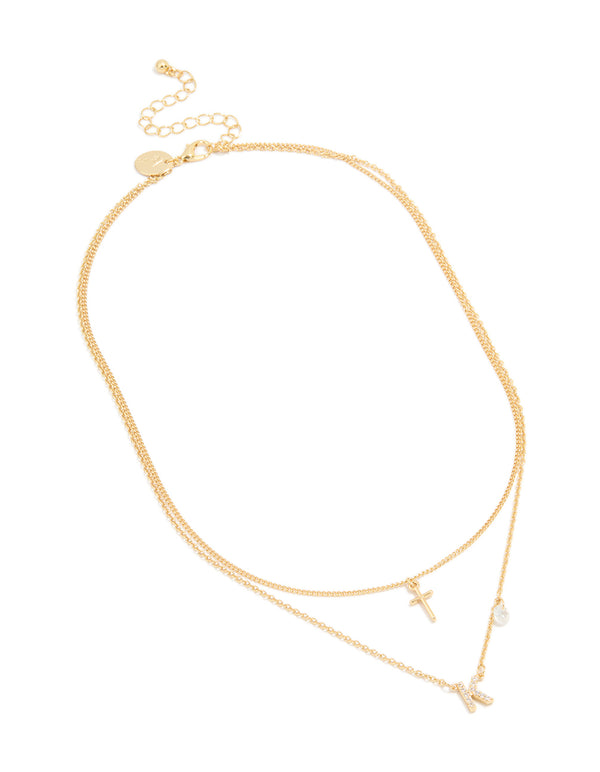 Displaying a layered necklace with cross and letter K charms in gold plated material featuring cubic zirconia with statement style front view