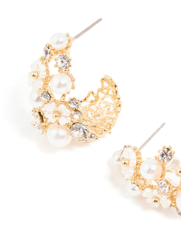 Highlighting gold plated flower diamante pearl graduating hoop earrings with floral design and hoop closure close up view