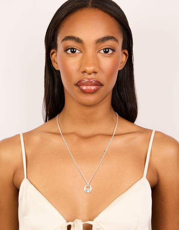 Featuring a waterproof stainless steel bold pendant necklace in silver on model view