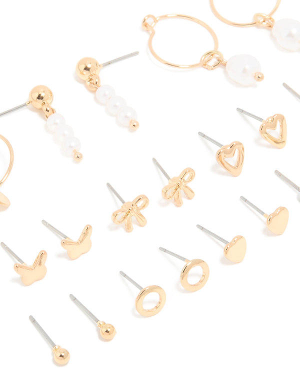 Discover dainty stud earrings with bow, butterfly, heart, charm and pearl details in gold close up view