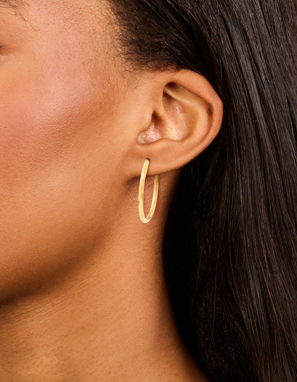 Featuring waterproof gold plated stainless steel clicker hoop earrings 30 MM on ear view