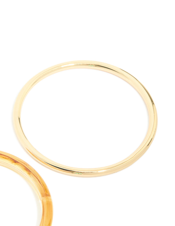 Featuring gold plated acrylic bangles in a 2-pack close up view