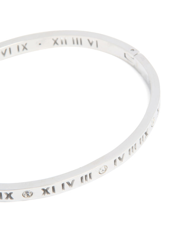 Featuring waterproof stainless steel construction, this diamante Roman numeral hinge bangle displays silver and clear stones detailing close up view