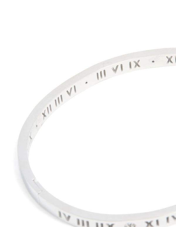 Featuring waterproof stainless steel construction, this diamante Roman numeral hinge bangle displays silver and clear stones detailing close up view