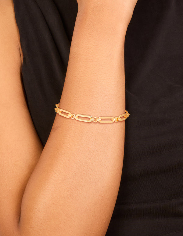 Showcasing a waterproof gold plated stainless steel open oval link bracelet on wrist view
