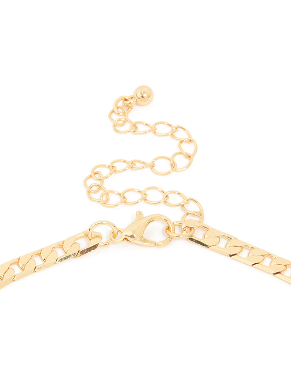 Detailed curb chain necklace featuring cross in gold plated finish with statement styling clasp detail view