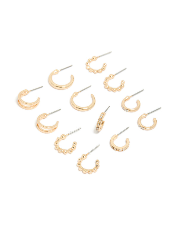 Showcasing dainty hoop earrings in a 6-pack set in gold finish front view
