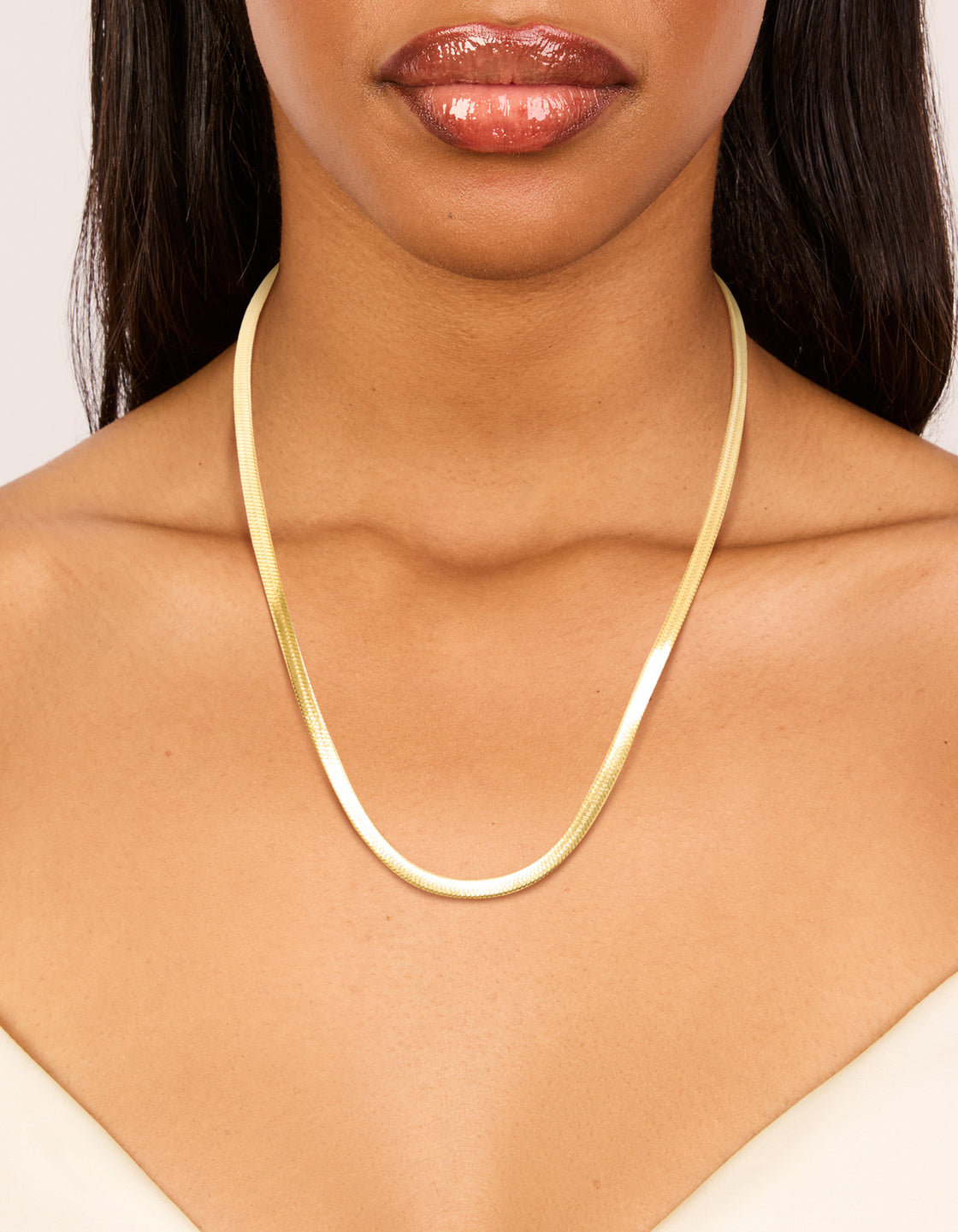 Featuring the waterproof gold plated stainless steel fine flat snake chain necklace on neck view