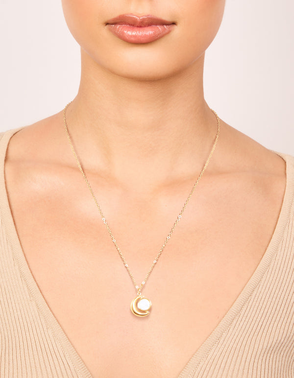 Showcasing a waterproof celestial necklace with full and crescent moon phase design in stainless steel gold plated finish on neck view