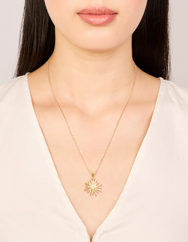 Featuring a waterproof gold plated stainless steel sunburst necklace with celestial and statement design on neck view