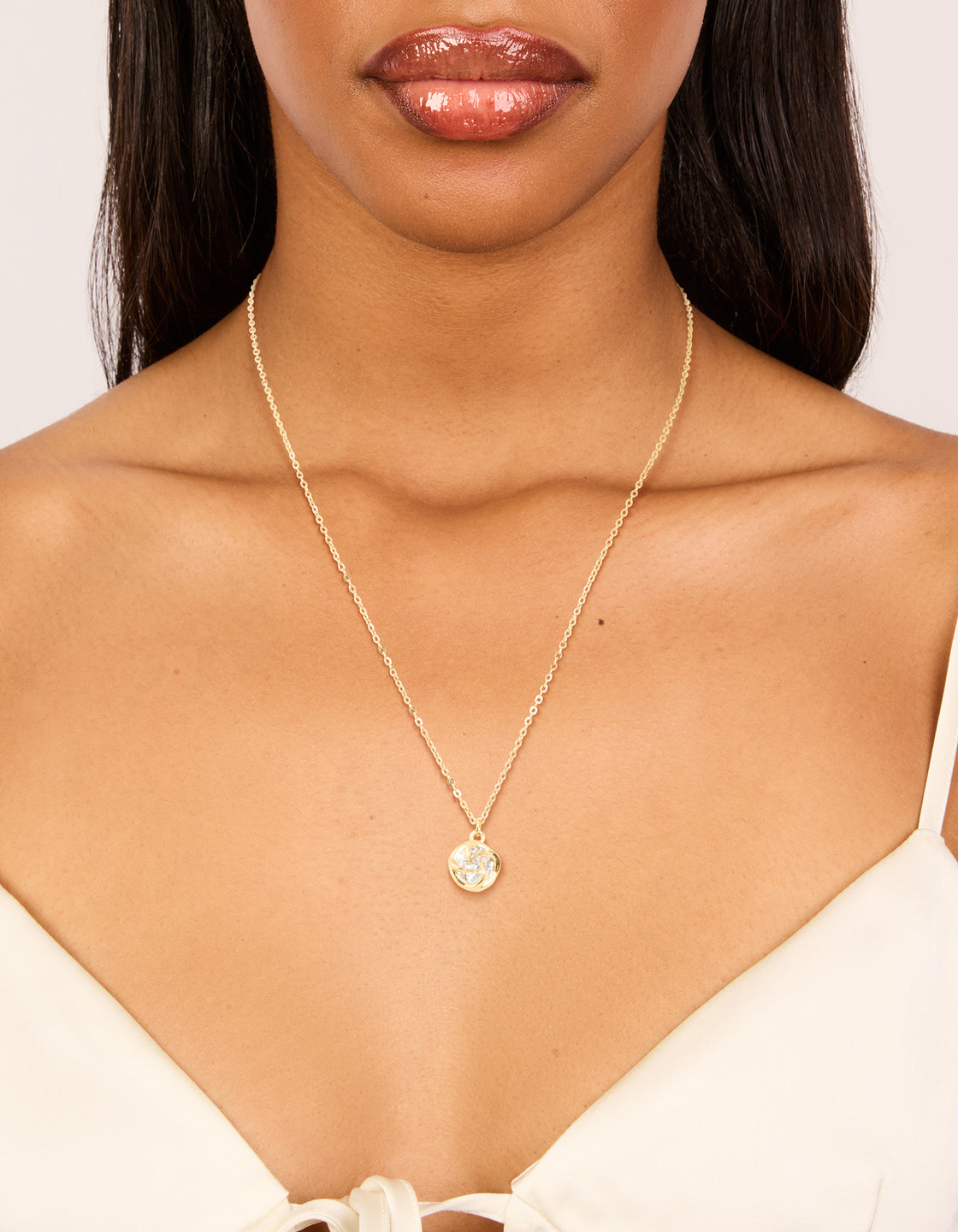 Showcasing a waterproof gold plated stainless steel cubic zirconia claw-set pendant necklace on neck view