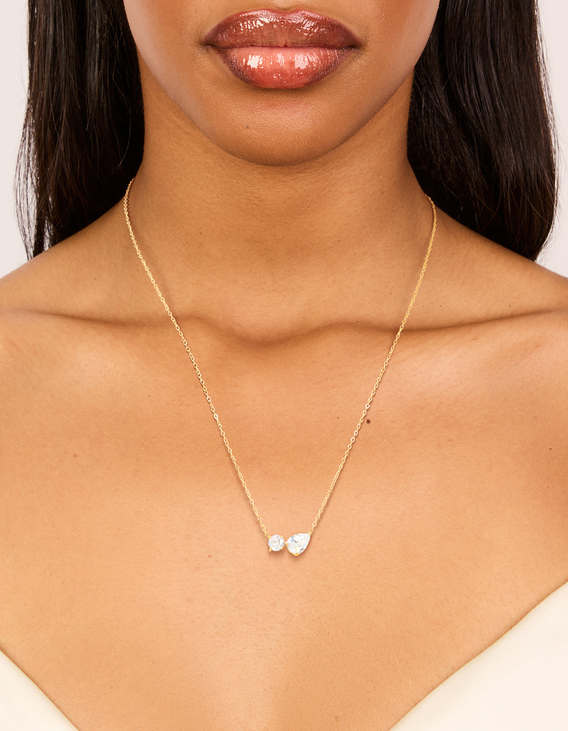 Featuring a waterproof gold plated stainless steel cubic zirconia mixed shape pendant necklace, crystal features, and dainty style on neck view