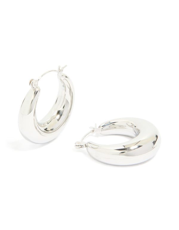 Showcasing waterproof stainless steel small chunky huggie earrings with closure in silver front view