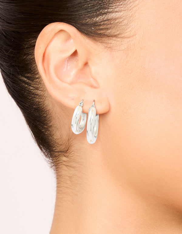 Featuring waterproof stainless steel tube hoop earrings in a 2-pack with silver hoop closure on ear view