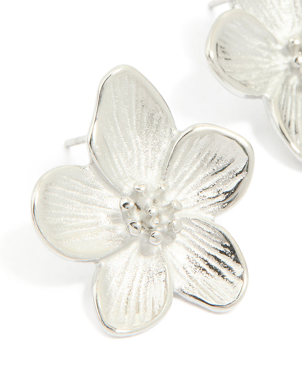 Showcasing mini textured flower earrings in waterproof stainless steel with floral pattern in silver close up view