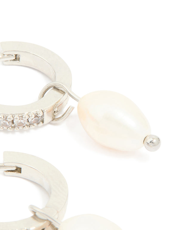 Featuring drop huggie earrings in waterproof stainless steel with freshwater pearl and diamante post detail view